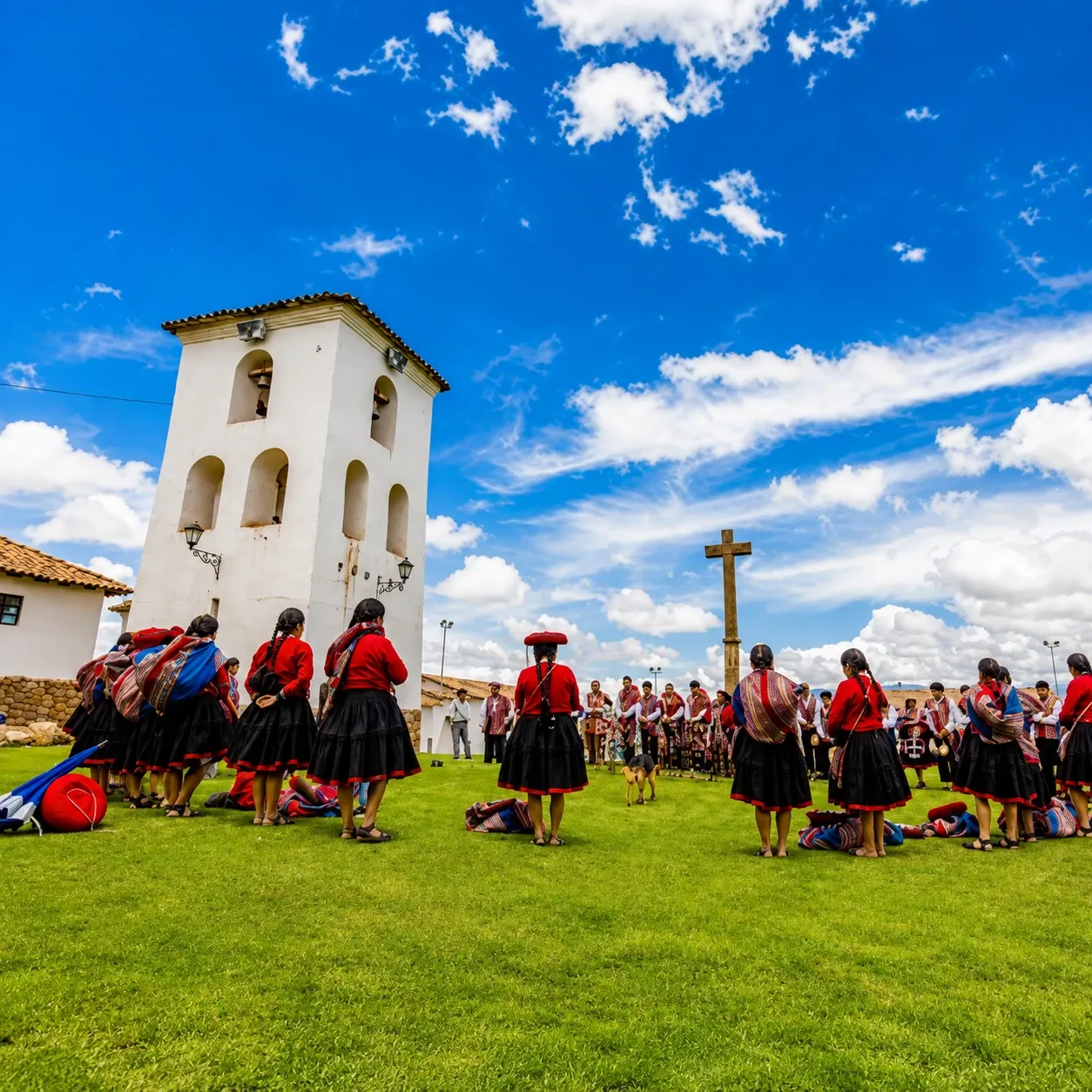 A gathering in traditional dress outside a colonial church tower
