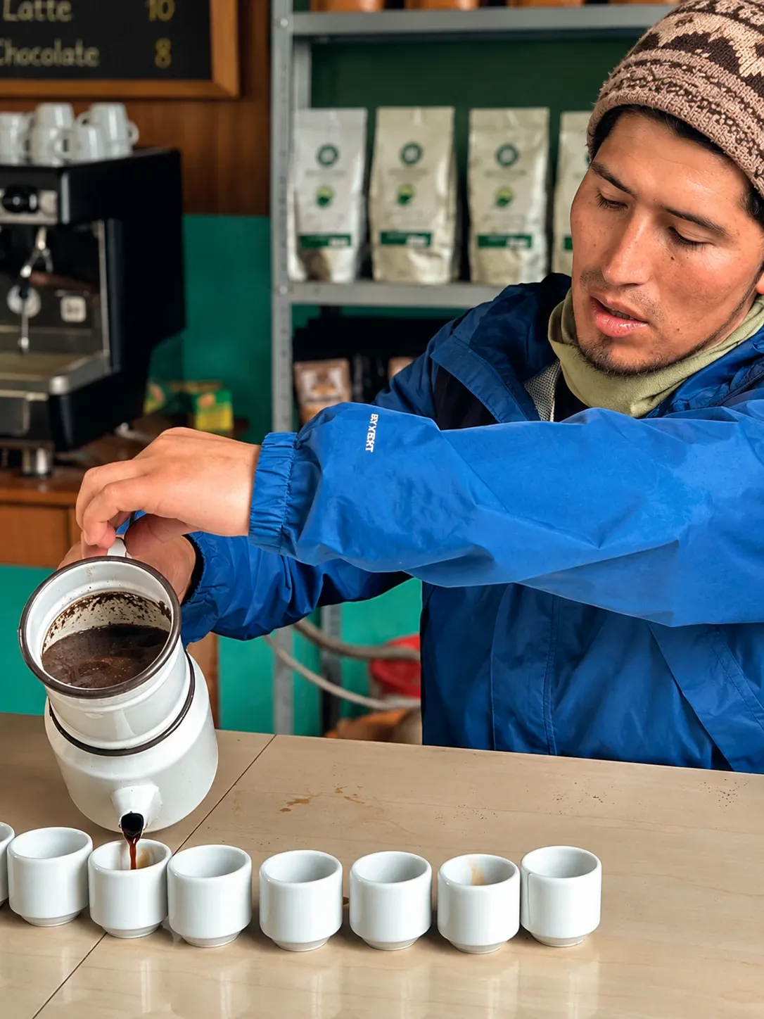Coffee being poured into tasting cups at a local farm