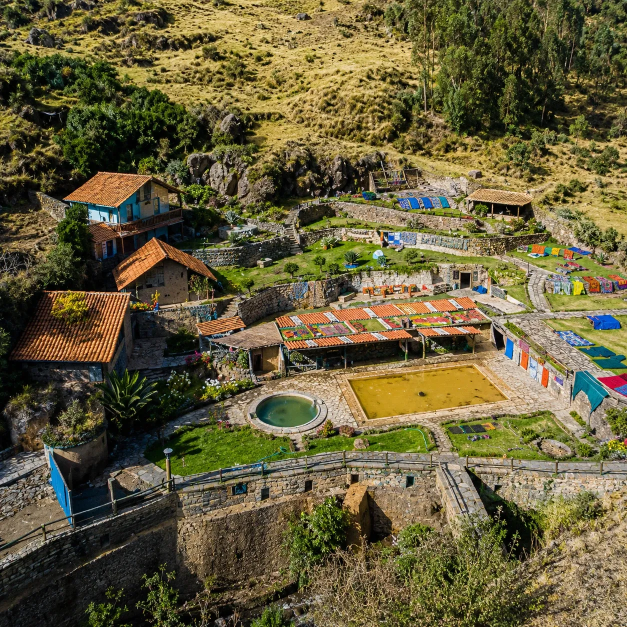 Thermal pools and gardens seen from above in a jungle valley