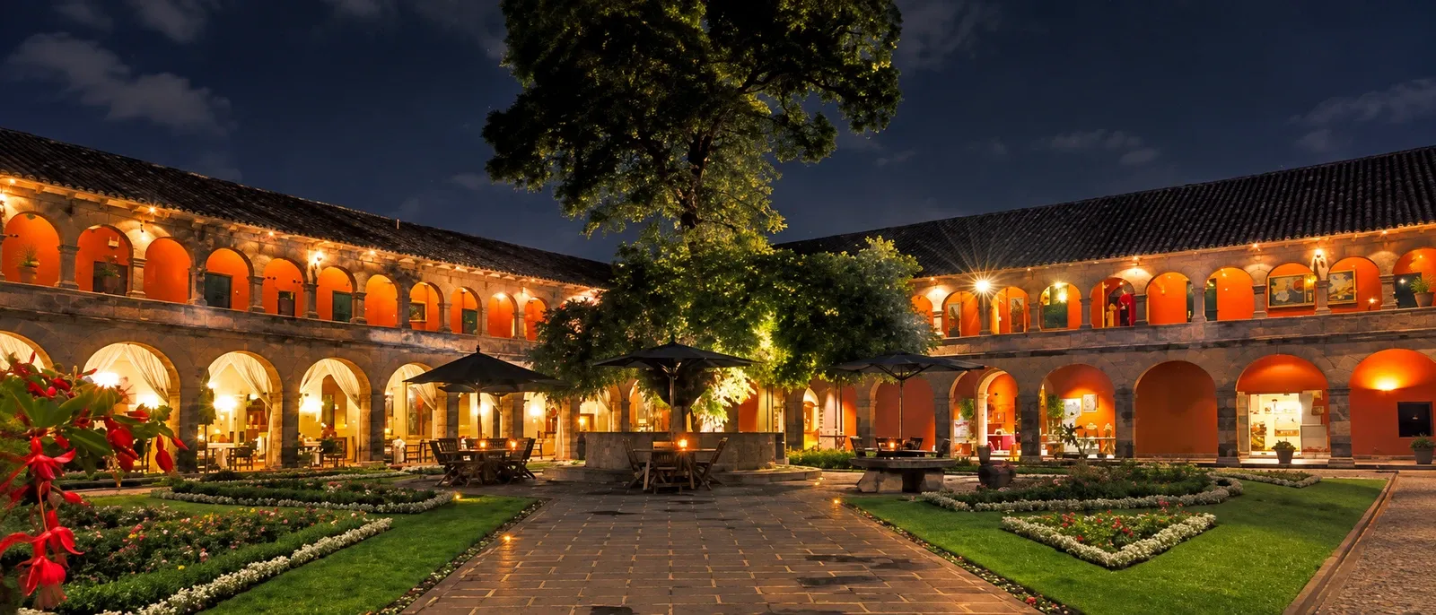 A colonial hotel courtyard lit up at night