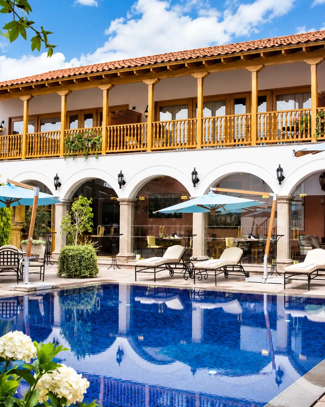 A colonial-style hotel courtyard with a pool