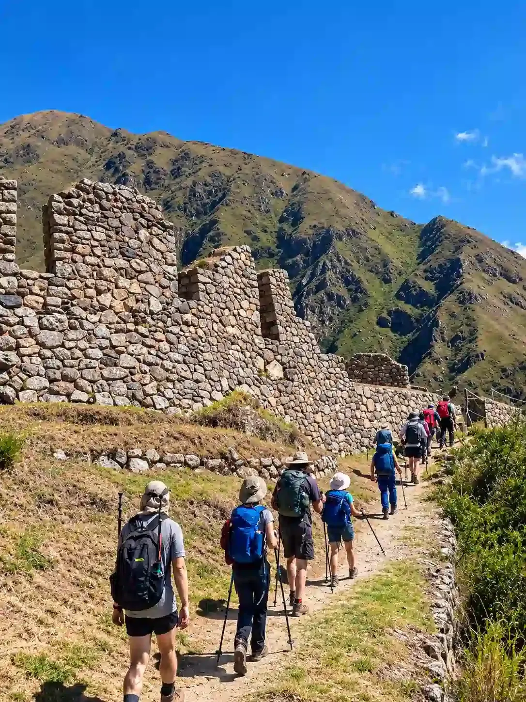 Walkers filing past Inca walls on the first day of the trail
