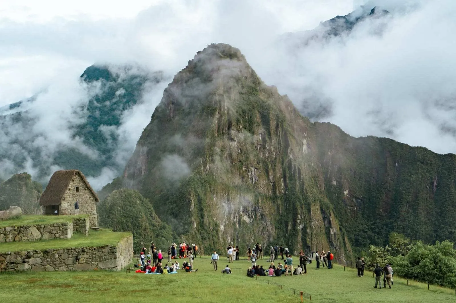 Visitors on the lawn below the guardhouse at Machu Picchu