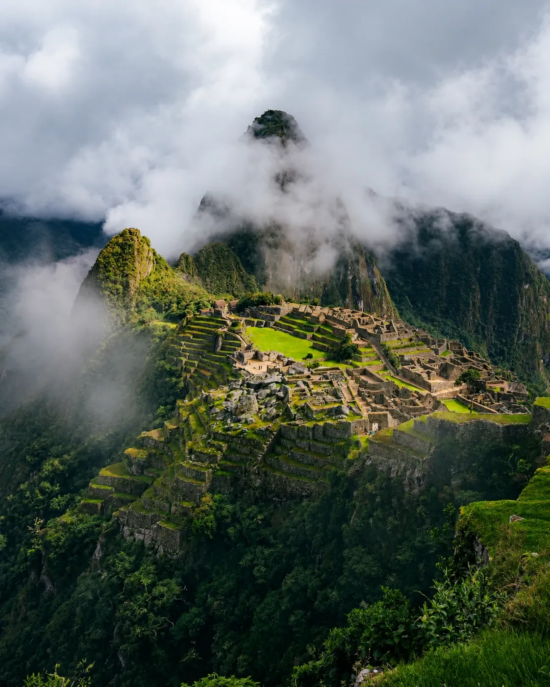 Machu Picchu appearing through morning cloud