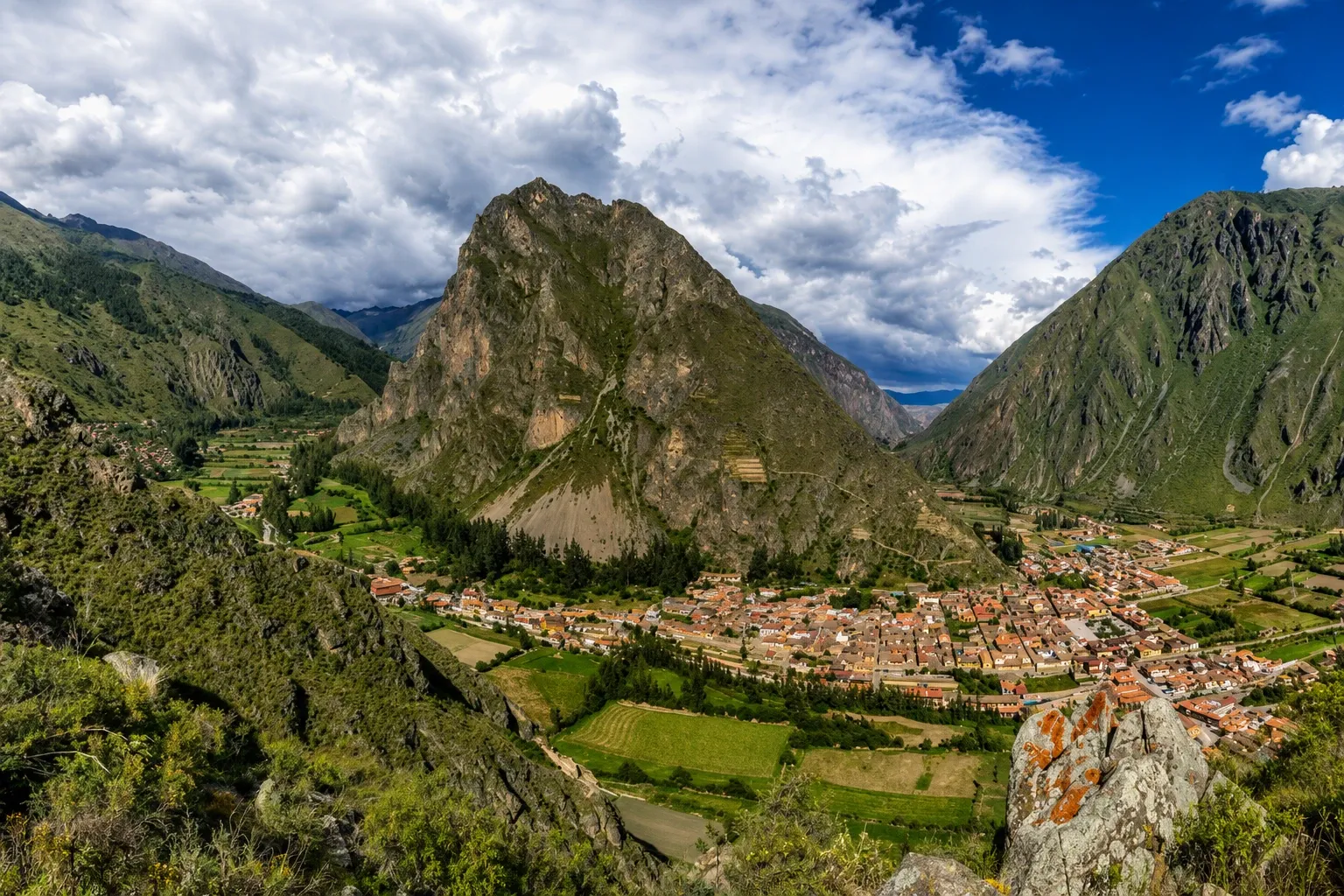 The town of Ollantaytambo on the valley floor beneath its mountain