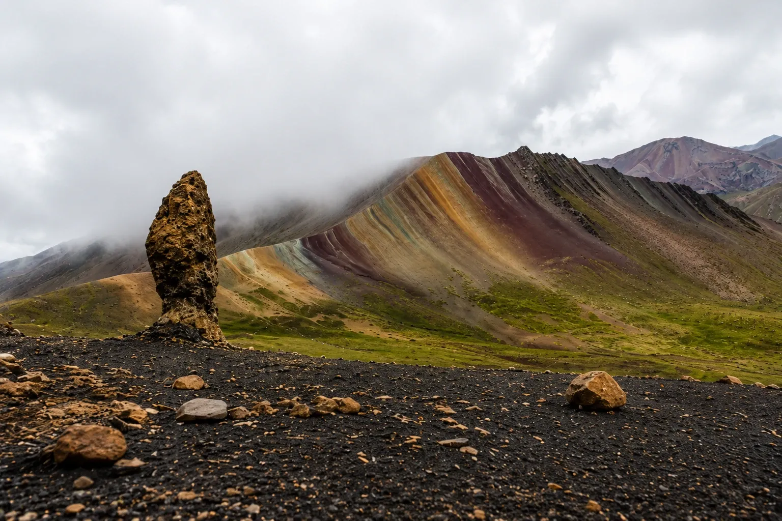 A rock spire in the stone forest at Palcoyo, striped hills behind