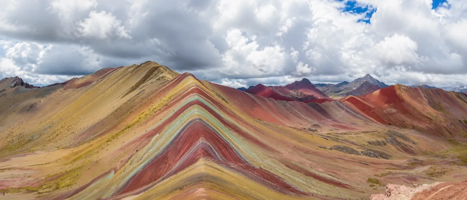 Rainbow Mountain's bands of colour running to the horizon