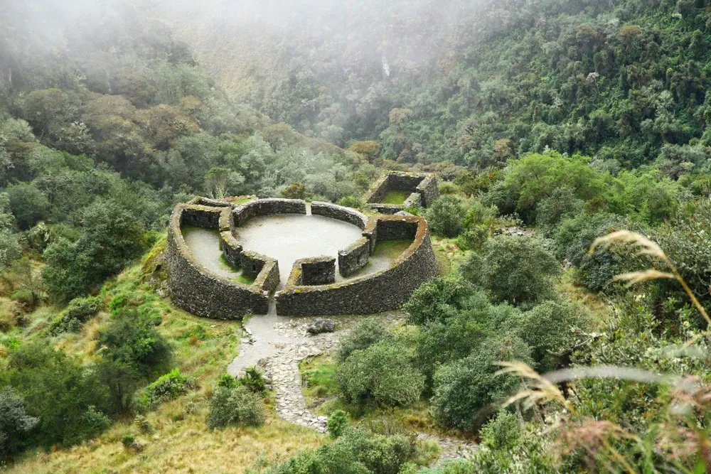 The round walls of Runkurakay among cloud forest