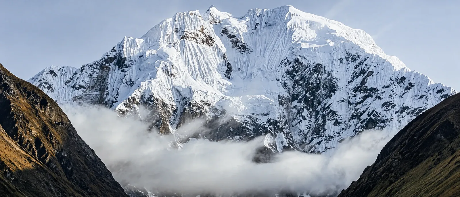 The snow-covered Salkantay massif rising above the cloud