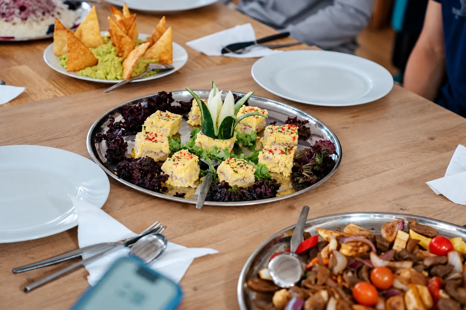 Platters of freshly cooked food on a wooden table