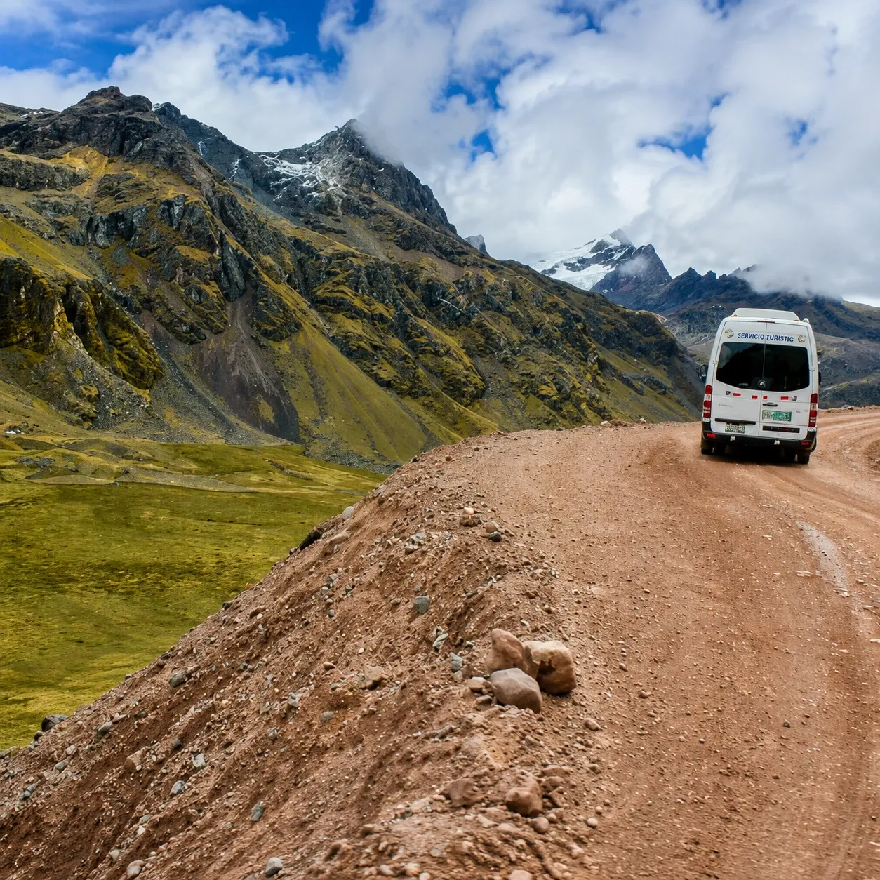 A minibus on a dirt road high in the Andes